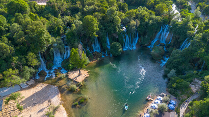 Naklejka premium Scenic Aerial Drone View of Kravica Waterfall and Emerald River Pool in Bosnia and Herzegovina