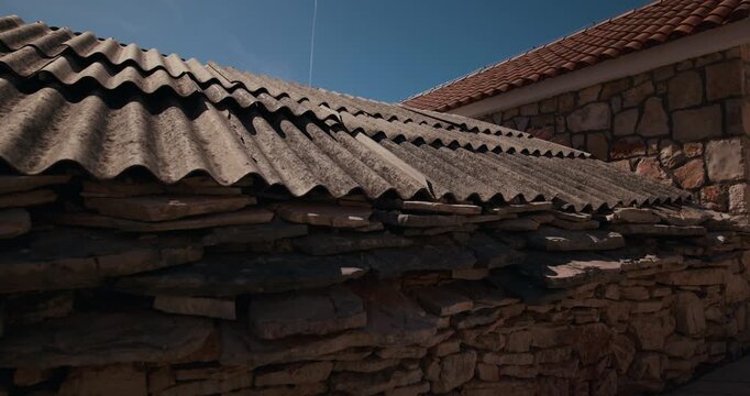 Low angle view of traditional stone architecture and tiled roofs in Primosten old town, Croatia.