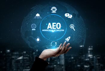 Obraz premium Hand Holding Globe with AEO Icon and Digital Symbols Representing Global Connectivity and Technology Solutions for Optimization and Engagement Fluxor.