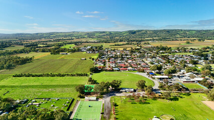 Fototapeta premium McLaren Flat, South Australia – 4K aerial drone footage of rural township, vineyards, farmland, residential streets, houses, scenic countryside, agricultural and wine region views in Adelaide Hills