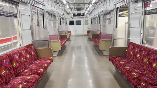 Interior view of an empty commuter train carriage after passengers have disembarked, showing public transportation seating and urban transit infrastructure.