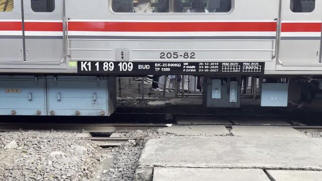 Low-angle footage of train wheels rolling on railway tracks, highlighting rail transportation, engineering, and infrastructure concepts.