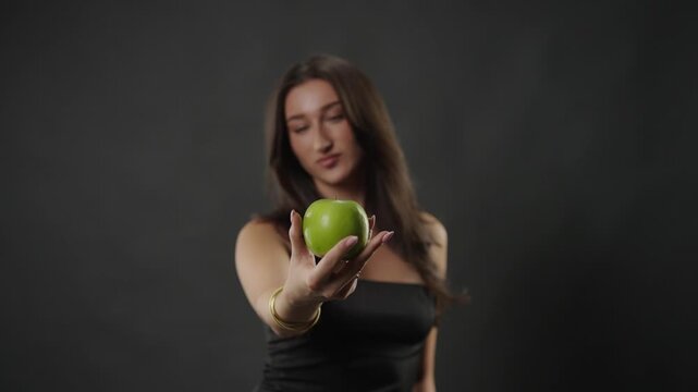 A young woman extends her hand, offering a crisp green apple. This image healthy lifestyle choices, nutrition, and the concept of temptation versus wellness. The fresh fruit natural goodness and a com