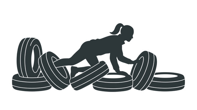 Silhouette of a woman navigating through an obstacle course of tires.