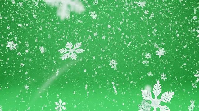 White winter snowflakes falling gently against a bright green background