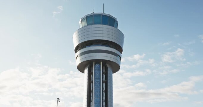 Control navigation building of air traffic, command tower against cloudy sky on a sunny day