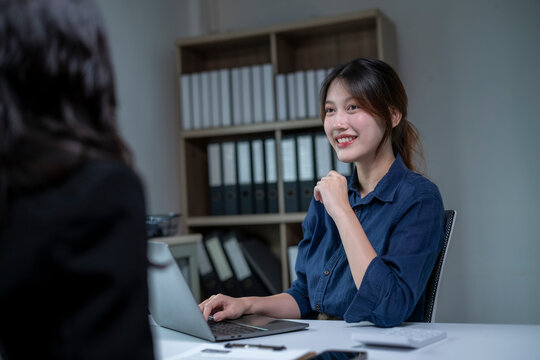 Young woman smiling and talking during a professional interview in office setting