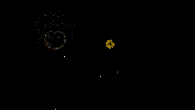 Colorful heart shaped fireworks display exploding in night sky as festive celebration background.