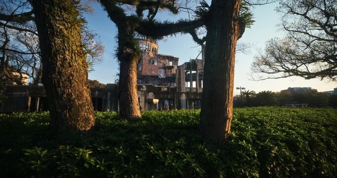 Sunset Glow On Hiroshima Peace Memorial Atomic Bomb Dome Framed by Trees, Steady Cam Shot