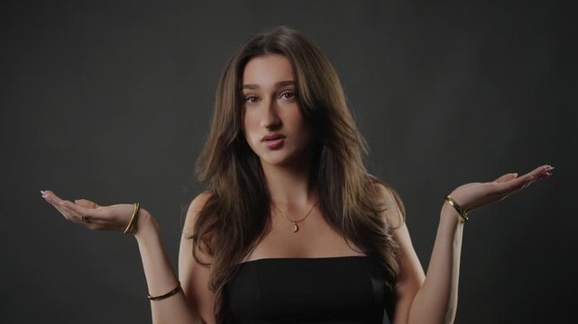 Uncertainty and confusion concept with a young woman shrugging, her hands open and a puzzled expression on her face. This image doubt, indecision, and the universal human experience of not knowing an 