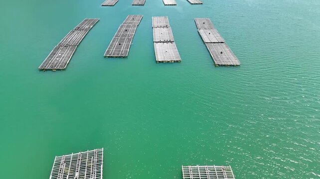 aerial 4K video of floating fishing boxes in the river between mountains in japan