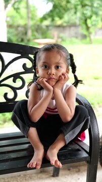 Sad upset pensive thoughtful little offended Caucasian child girl orphan unhappy bad mood lonely kid at home kitchen alone boring stressed daughter sadness family problem domestic violence thinking