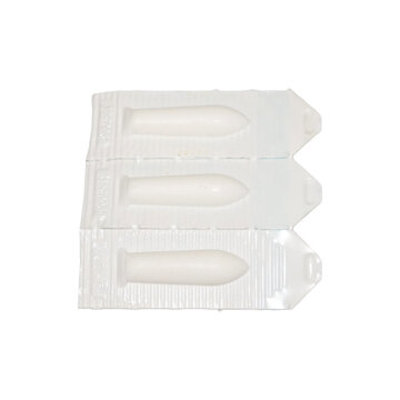 Three pharmaceutical suppositories in individual sterile blister packaging with soft natural lighting and copy space
