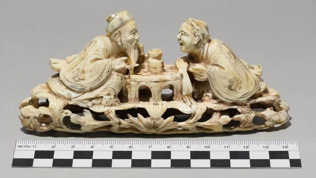 confiscated. Confiscated ivory carving on plain surface under harsh lighting. wildlife magazines, conservation campaigns, designed for nature documentaries and education.