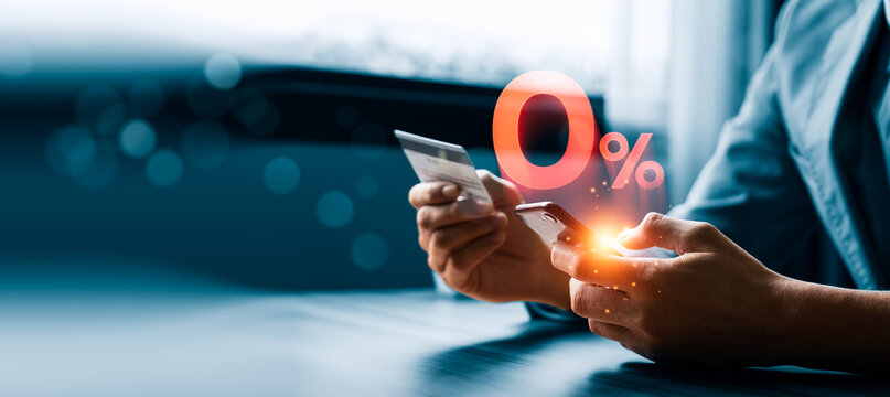 Zero percent payment concept with customer using smartphone and credit card showing promotional interest free offer for online shopping checkout finance and digital retail purchase