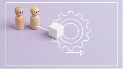 Fototapeta premium Two wooden figures approach a cube, symbolizing teamwork and mechanical process.