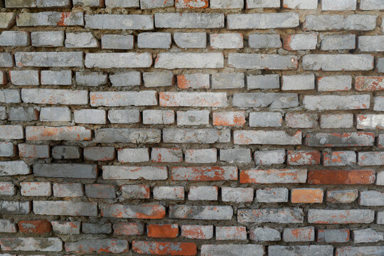 Old brick wall texture with various colored bricks showing weathered appearance