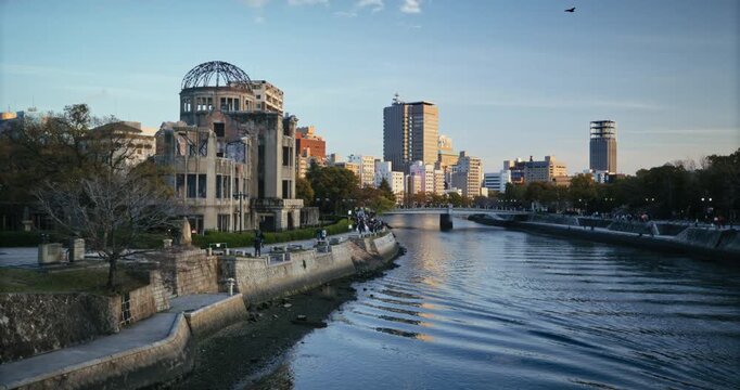 Hiroshima Peace Memorial Atomic Bomb Dome Near Rippling River At Dusk - Wide Shot