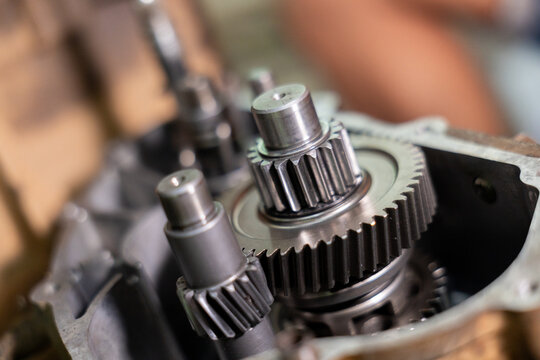 Close up gear metal machinery mechanical engineering industrial steel precision technology gears gearbox showing detailed teeth and shafts representing mechanical engineering and industrial