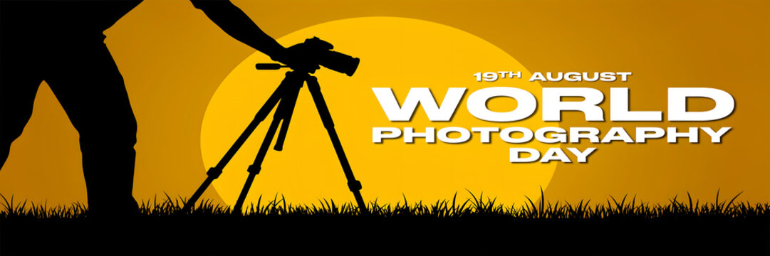 Photographer with tripod and camera against a large sun at sunset