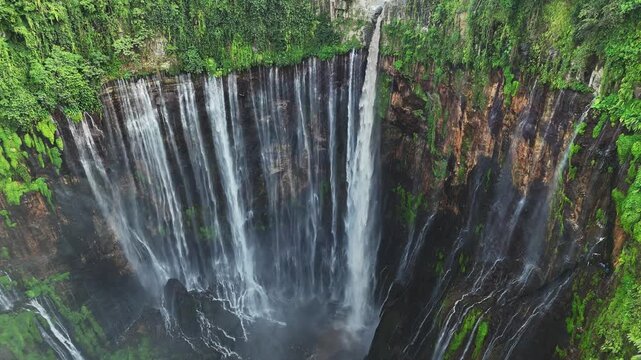 Aerial view of Tumpak Sewu waterfall is one of the most stunning waterfalls in Indonesia, standing at 120 meters tall with the most insane panorama view.