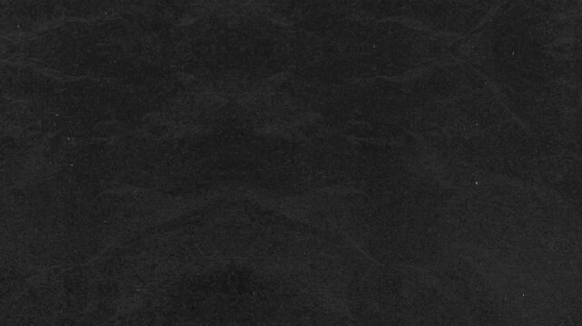 Grunge background dark textured charcoal stone grain surface suitable for backgrounds, textures, or architectural designs, featuring solid rough pattern matte grey material.