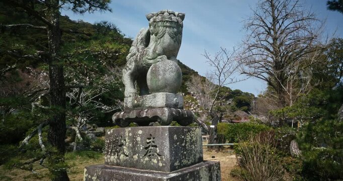 Ancient Stone Komainu Guardian Lion Statue at Japanese Shrine Hiroshima - Steady Cam Movement