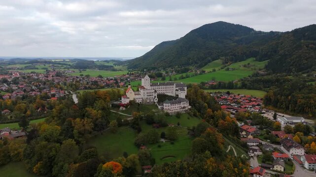 Cloudy drone footage of Hohenaschau Castle, Aschau im Chiemgau, Bavaria, Germany, mist covering valley, autumn forest and mountains
