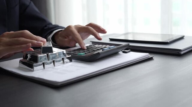 Asian businessman using calculator calculate silver price