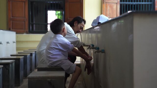 A series of photos showing a heartwarming moment of an adult teaching and helping a young Muslim boy perform Wudu (Islamic ritual purification) at a mosque's ablution area before prayer.