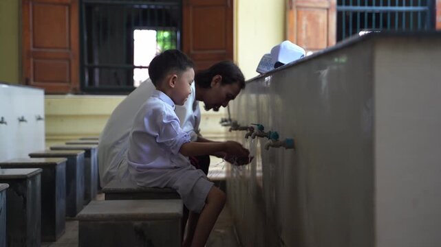 A series of photos showing a heartwarming moment of an adult teaching and helping a young Muslim boy perform Wudu (Islamic ritual purification) at a mosque's ablution area before prayer.
