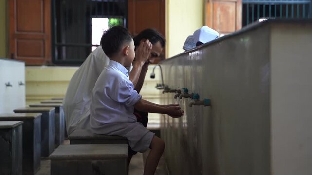A series of photos showing a heartwarming moment of an adult teaching and helping a young Muslim boy perform Wudu (Islamic ritual purification) at a mosque's ablution area before prayer.