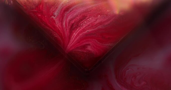 Acrylic ink. Geometric abstraction. Defocused red yellow purple color drip texture vibrant cube droplets pour on creative art background.