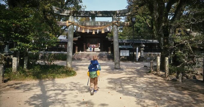 Slow Motion Of Child Walking Toward Torii Gate at Japanese Shinto Shrine In Hiroshima, Japan