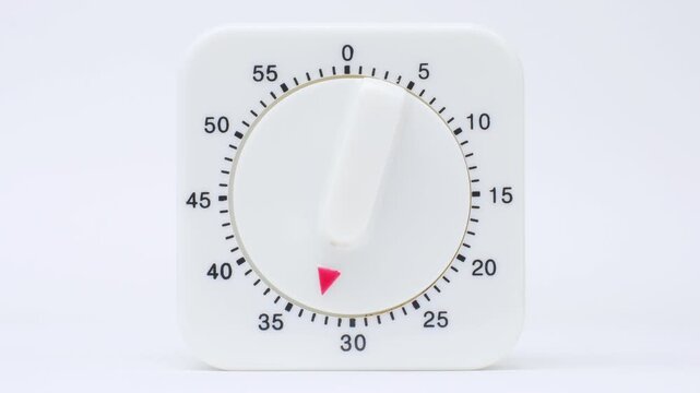 Time lapse of a kitchen clock timer countdown to zero.