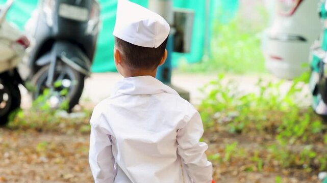 young kid back view with wearing ethnic marathi traditional cap