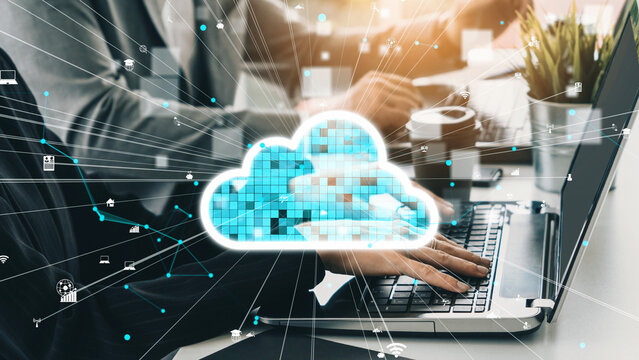 A modern workspace featuring a laptop and cloud technology representation, symbolizing digital transformation and data visualization in today business environment. Xenic