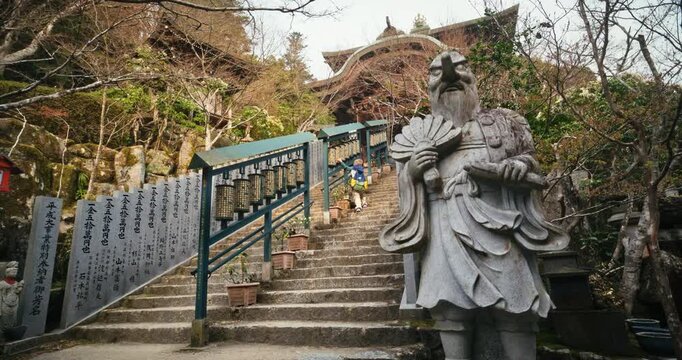 Ancient Stone Guardian Statue at Japanese Temple And Staircase In Hiroshima, Japan