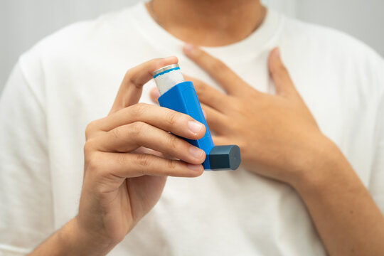Asthma and chronic obstructive pulmonary disease COPD, Asian teenage using metered dose inhaler MDI.