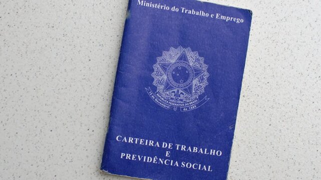 Brazilian Work ID. Unemployment, job, or salary increase. On a clear surface: Employment symbols reflected on the ID, depicting the pursuit of opportunities, laid on an illuminated table.