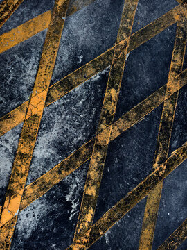 Navy textured surface crossed by gold diagonal lines, grainy indigo ground with speckled paint.