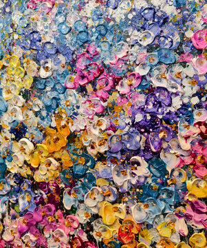Vibrant messy artist palette covered in glossy paint, scattered brushes and tubes, dried paint