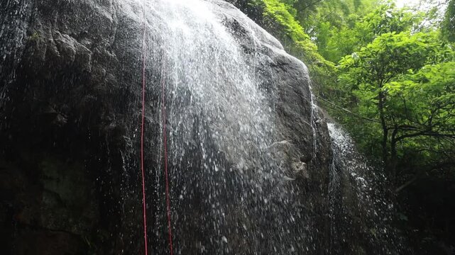 Stream cascades down waterfalls, rushing water, slow-motion shooting.