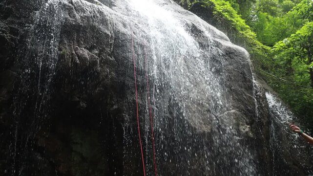 Stream cascades down waterfalls, rushing water, slow-motion shooting.