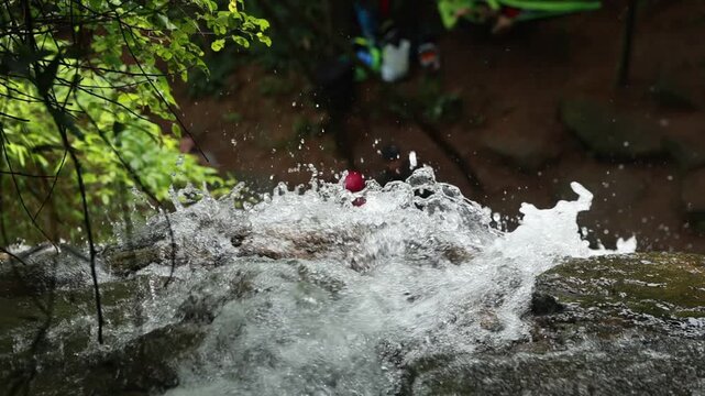 Stream cascades down waterfalls, rushing water, slow-motion shooting.