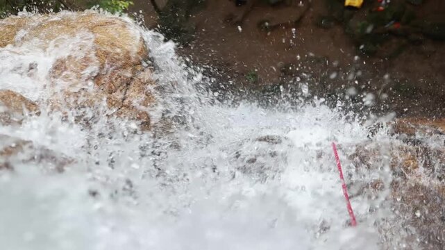 Stream cascades down waterfalls, rushing water, slow-motion shooting.