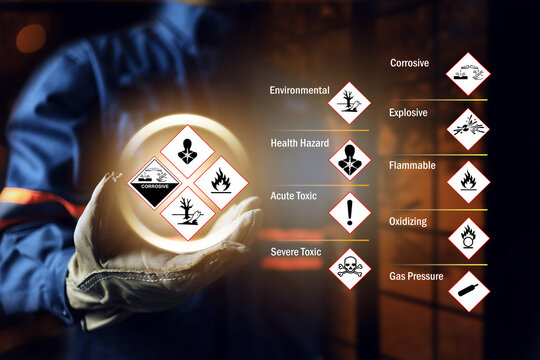 Materials safety data sheet concept with safety staff wearing leather glove holding GHS globally harmonized safety chemical hazard sign to warning in working site