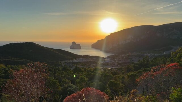Golden sunset illuminates Pan di Zucchero and the Sardinian coastline as viewed from the famous Strada Panoramica.