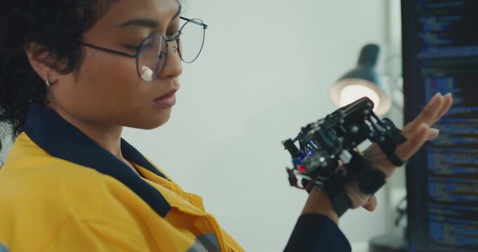 Young Black female engineer coding AI robot arm in modern laboratory. Robotics, artificial intelligence, technology, stem, future, innovation, diversity, automation, machine learning concept.