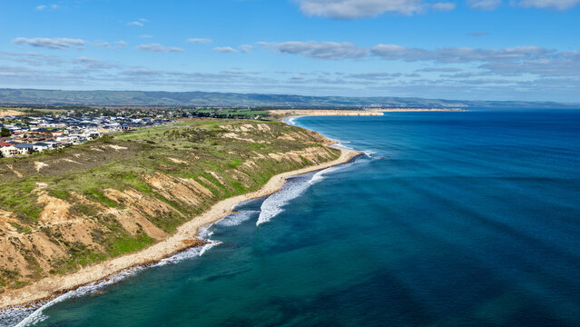 Moana, South Australia &ndash; 4K aerial drone view of coastal cliffs, sandy beach, turquoise ocean, suburban homes, Maslin beach, scenic coastline and seaside landscapes in South Adelaide